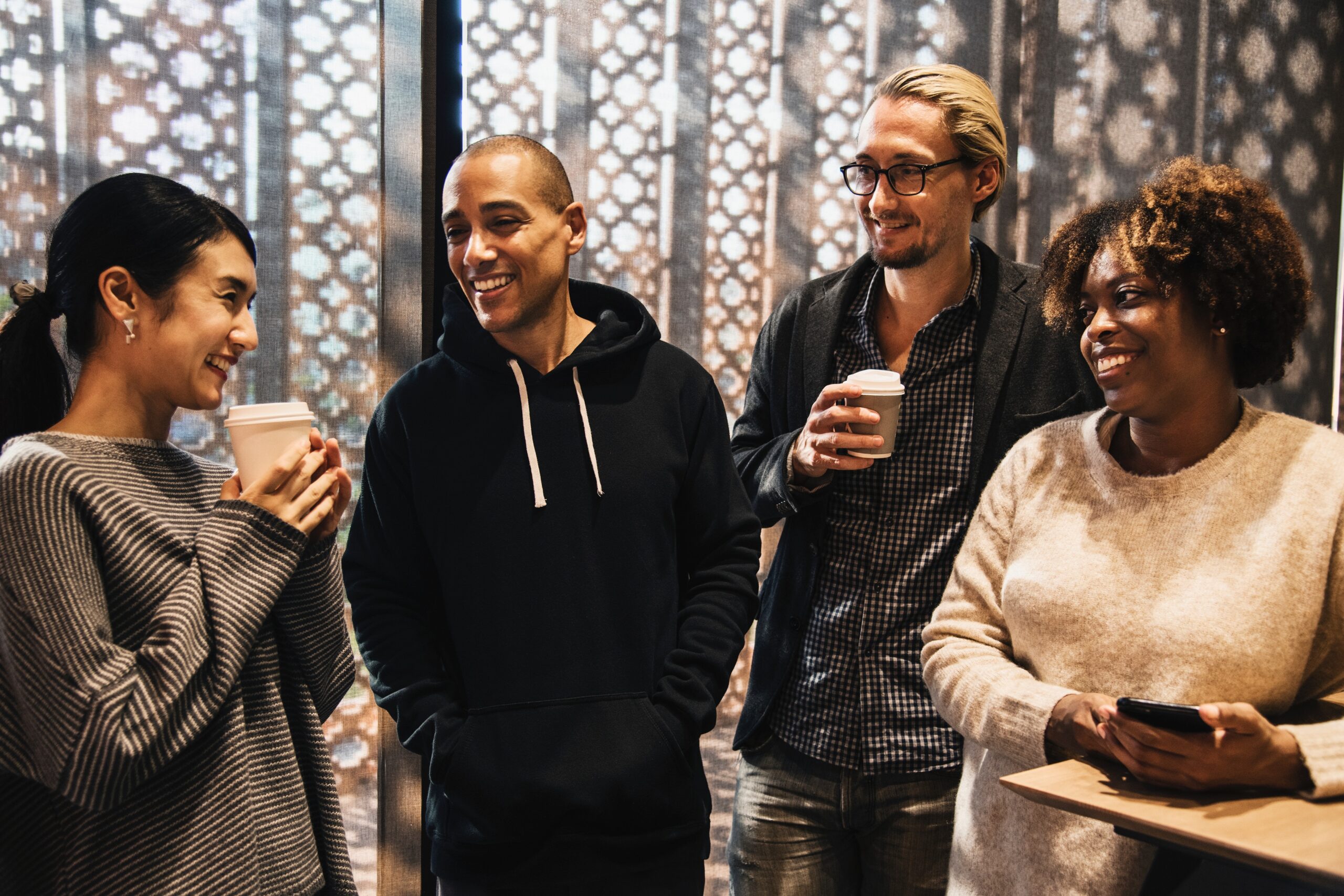 Diverse group of church members chatting and drinking coffee together